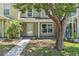 Inviting two-story home exterior featuring a covered entrance and well-maintained landscaping at 283 Woodgreen Ln, Winter Springs, FL 32708
