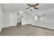 Open living area with laminate floors, a staircase, and a pass-through window to the kitchen at 283 Woodgreen Ln, Winter Springs, FL 32708