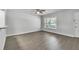 Bright living room featuring laminate flooring and a large window for plenty of natural light at 283 Woodgreen Ln, Winter Springs, FL 32708