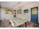 Comfortable back porch features brick flooring with an outdoor dining area and mounted television at 3007 Huntington St, Orlando, FL 32803