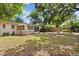 Large, shaded backyard with a hammock and hanging chair provides an outdoor leisure space at 3007 Huntington St, Orlando, FL 32803
