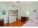 Sunlit bedroom boasts a built-in dresser, decor, and hardwood flooring at 3007 Huntington St, Orlando, FL 32803
