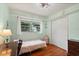 Cozy bedroom with light green walls, hardwood floors, and closet at 3007 Huntington St, Orlando, FL 32803