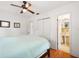 Bedroom boasts hardwood floors and a ceiling fan; ensuite bathroom is accessible via a doorway at 3007 Huntington St, Orlando, FL 32803
