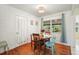 Cozy dining room with wood floors, a round table with chairs, and natural light from the window at 3007 Huntington St, Orlando, FL 32803