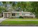 Charming single-story home featuring a light pink exterior, quaint front yard and a light teal colored front door at 3007 Huntington St, Orlando, FL 32803