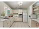 Functional kitchen featuring white cabinets and appliances, including a built-in oven and tiled backsplash at 3007 Huntington St, Orlando, FL 32803