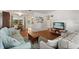 Bright living room featuring wood floors, a comfortable sofa and love seat, and an adjacent dining area at 3007 Huntington St, Orlando, FL 32803