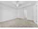 Spacious bedroom with plush carpeting, a ceiling fan, and ample natural light at 304 N Jungle Rd, Geneva, FL 32732