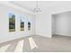 Bright dining room with large windows, tile floors, and a modern chandelier at 304 N Jungle Rd, Geneva, FL 32732