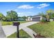 Modern home with dark grey roof, dark grey garage doors, and well-maintained landscaping at 304 N Jungle Rd, Geneva, FL 32732