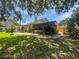 Spacious backyard with lush greenery, stone pathways, and privacy fencing at 306 Foxboro Ct, Lake Mary, FL 32746
