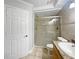 Bathroom featuring tiled walk-in shower with glass doors, toilet, vanity and large door at 306 Foxboro Ct, Lake Mary, FL 32746