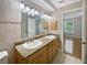 Bathroom with double sinks, decorative tile, and modern fixtures at 306 Foxboro Ct, Lake Mary, FL 32746
