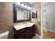 Bathroom featuring vanity, decorative mirror, hardware, and access to another room at 306 Foxboro Ct, Lake Mary, FL 32746
