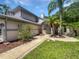 Charming two-story home with landscaped front yard, walkway and mature palm trees at 306 Foxboro Ct, Lake Mary, FL 32746