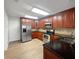 Modern kitchen with stainless steel appliances, granite countertops, and wood cabinets at 306 Foxboro Ct, Lake Mary, FL 32746