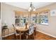 Bright dining area with stylish floral chairs, wood floors, and modern lighting at 3118 Walnut St, Winter Haven, FL 33881