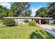 Charming single-story home with a well-maintained lawn and a covered carport at 3118 Walnut St, Winter Haven, FL 33881