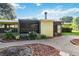 View of the front yard and entrance, featuring a brick walkway, stone features, and fresh landscaping at 3118 Walnut St, Winter Haven, FL 33881