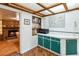 Functional kitchenette with wood floors, cabinets, a microwave and access to another room at 3118 Walnut St, Winter Haven, FL 33881