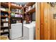 Functional laundry room with wooden shelves and new washer and dryer at 3118 Walnut St, Winter Haven, FL 33881