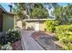 View of the yard, including a brick path, a storage shed, and additional landscaping at 3118 Walnut St, Winter Haven, FL 33881
