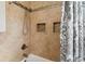 Shower tub with tiled walls, built-in shower niches, and a modern shower head at 3118 Walnut St, Winter Haven, FL 33881