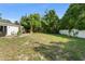 Large backyard with newly installed fence, mature trees, and space for outdoor activities at 3270 Courtland Blvd, Deltona, FL 32738