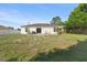 Spacious backyard with mature trees, a lawn, and a patio area perfect for outdoor entertaining at 3270 Courtland Blvd, Deltona, FL 32738