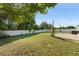 Sprawling backyard featuring lush grass, mature trees, and a newly installed white fence at 3270 Courtland Blvd, Deltona, FL 32738