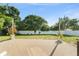 Expansive backyard featuring a paved patio, lush trees, and a newly installed white fence at 3270 Courtland Blvd, Deltona, FL 32738