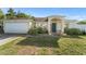 Charming single-story home with a two-car garage, manicured landscaping, and welcoming front porch at 3270 Courtland Blvd, Deltona, FL 32738