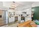 Bright kitchen with white cabinets, stainless steel appliances, and a view to the exterior at 3270 Courtland Blvd, Deltona, FL 32738