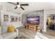 Bright living room showcasing a large TV, comfortable seating, and an open view to a well-lit kitchen area at 3270 Courtland Blvd, Deltona, FL 32738