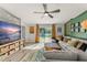 Bright living room featuring a large TV, comfortable seating, a patterned rug, and access to the outdoor area at 3270 Courtland Blvd, Deltona, FL 32738