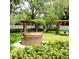 Community space featuring a brick outdoor fire pit, pergola, benches, and green lawn at 3312 Bridgeford Dr, Orlando, FL 32812