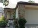 Charming single-story home featuring a brick facade, attached garage, and well-maintained landscaping at 3312 Bridgeford Dr, Orlando, FL 32812