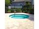 Community hot tub surrounded by lush landscaping and a privacy fence at 3312 Bridgeford Dr, Orlando, FL 32812