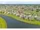 Aerial view of home featuring a pond, located in a residential neighborhood at 356 Quarry Rock Cir, Kissimmee, FL 34758