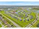 An aerial view of a residential community featuring single-Gathering homes, serene ponds, and lush green spaces at 356 Quarry Rock Cir, Kissimmee, FL 34758
