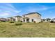 A sprawling backyard, offering a blend of manicured lawn and serene outdoor relaxation space at 356 Quarry Rock Cir, Kissimmee, FL 34758