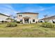 A rear exterior with a partially covered patio and well-maintained lawn in a spacious backyard at 356 Quarry Rock Cir, Kissimmee, FL 34758