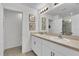 Bright bathroom with double sinks, framed mirrors, neutral countertops and a walk-in shower at 356 Quarry Rock Cir, Kissimmee, FL 34758