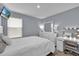 Bedroom features carpeted floors, a window, bed, TV, dresser, and vanity mirror with lights at 356 Quarry Rock Cir, Kissimmee, FL 34758