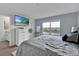 Comfortable bedroom featuring a TV, large window, and a serene water view at 356 Quarry Rock Cir, Kissimmee, FL 34758