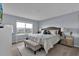 Bedroom with a bench, white nightstand, and a lake view at 356 Quarry Rock Cir, Kissimmee, FL 34758
