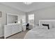 Bedroom features a large window, bed, dresser, mirror, and side table with decorative lighting at 356 Quarry Rock Cir, Kissimmee, FL 34758