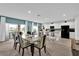 Dining area with a view of the modern kitchen with stainless appliances and a large kitchen island at 356 Quarry Rock Cir, Kissimmee, FL 34758