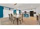 Open-concept dining room featuring a modern table and chairs with an adjacent kitchen at 356 Quarry Rock Cir, Kissimmee, FL 34758